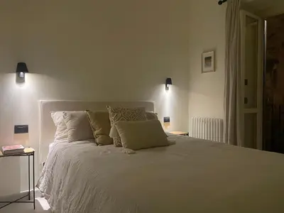 a kitchen with black cabinets and a tv on the wall at Apartment in the heart of Rome in Rome