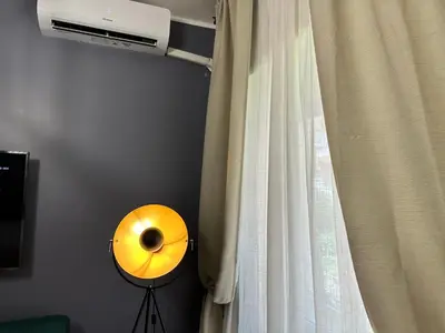 a yellow drum next to a window with a curtain at Roma Chic Flats Policlinico Gemelli in Rome