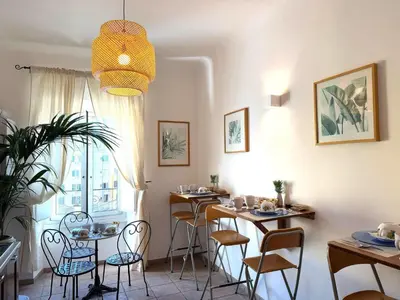 a dining room with tables and chairs and a window at Aenea's B&B in Rome