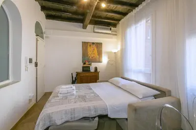 a bedroom with a bed and a window at Trevi Little Palace #3 in Rome