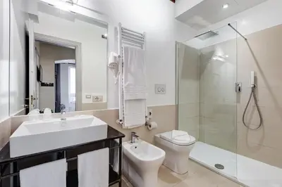 a bathroom with a sink and a toilet and a shower at Rome Frattina27 in Rome