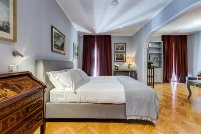 a bedroom with a bed and a dresser at Rome Frattina27 in Rome