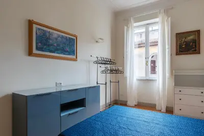 a living room with a blue cabinet and a blue rug at GuestHost - Bright & Roomy Apartment x6 - Trastevere District in Rome