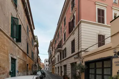 a car parked in an alley between buildings at GuestHost - Bright & Roomy Apartment x6 - Trastevere District in Rome