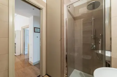 a bathroom with a shower with a glass door at GuestHost - Bright & Roomy Apartment x6 - Trastevere District in Rome