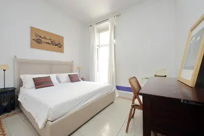 a bedroom with a bed and a desk and a window at Ottavia Terrace in Rome