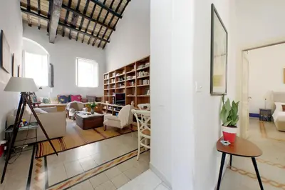 a living room with white walls and a large window at Ottavia Terrace in Rome
