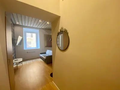 a living room with a mirror and a couch at Prestige Apartment Nazionale in Rome