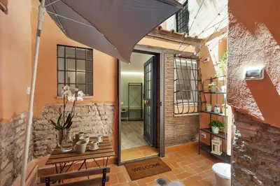 an open door into a room with a table and an umbrella at Pellegrino 113 in Rome
