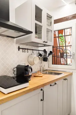 a kitchen with white cabinets and a counter with a sink at Pellegrino 113 in Rome