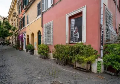 a street with potted plants in front of a building at [Trastevere - Rome] Strategic and Comfortable Loft in Rome