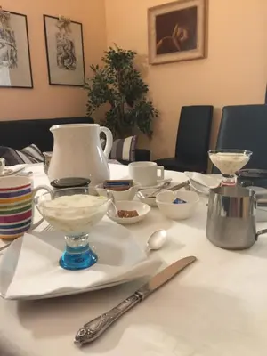 a table with white plates and bowls on it at B&B Eternal Rome Inn in Rome