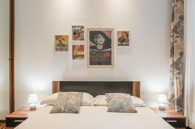 a bedroom with a bed with posters on the wall at The Best Rent - Three-Bedroom apartment near Villa Borghese in Rome