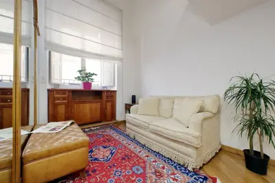 a living room with a couch and a rug at Suite Barberini in Rome