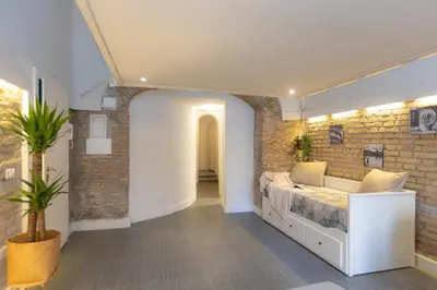 a bedroom with a bed and a brick wall at Casa Vinia in Rome
