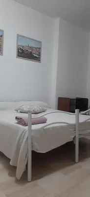 a white bed in a room with a picture on the wall at CorneliaGuestHouse in Rome