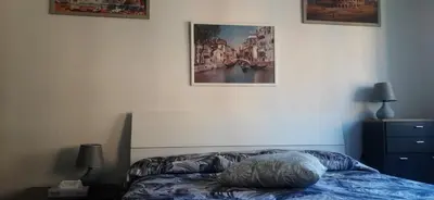 a bed in a bedroom with a picture on the wall at CorneliaGuestHouse in Rome