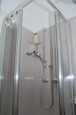 a bathroom with a shower with a glass door at Attico Monteverde in Rome