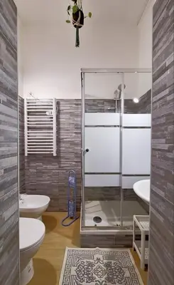a bathroom with two toilets and a glass shower at Pensiero Romano in Rome