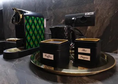 two black coffee cups sitting on a tray at Casa Orchidea in Rome