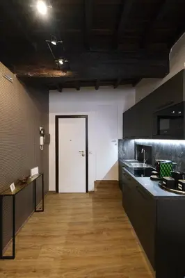 a kitchen with black counters and a white door at Casa Orchidea in Rome