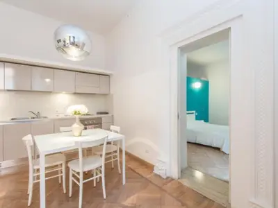 a kitchen and dining room with a white table and chairs at Sistina 143 A-B-C in Rome