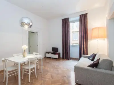a living room with a table and a couch and a dining room at Sistina 143 A-B-C in Rome