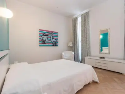 a white bedroom with a white bed and a window at Sistina 143 A-B-C in Rome