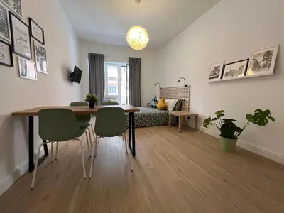 a living room with a dining room table and chairs at Appartamento Millelire in Rome