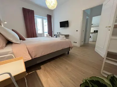 a bedroom with a large bed and a mirror at Appartamento Millelire in Rome