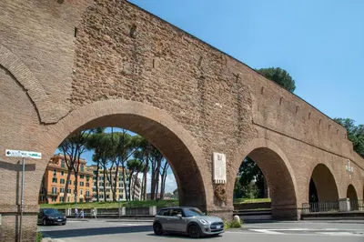 a car parked in front of a brick wall at Porta Castello Suites in Rome