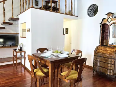 a dining room with a wooden table and chairs at Casa Lovera in Vaticano in Rome