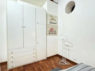 a bedroom with white cabinets and a bed at Casa Lovera in Vaticano in Rome