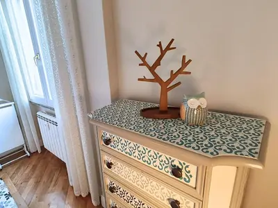 a dresser with a bonsai tree on top of it at Luxury Apartment by Palazzo Senesi in Rome