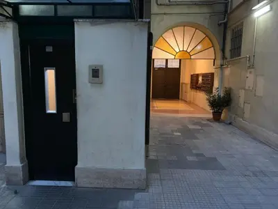 an empty hallway of a building with a black door at Termini GHome in Rome