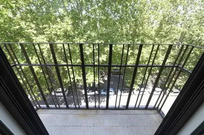 a balcony with a view of a parking lot at Testaccio Luminous and Large Apartment in Rome