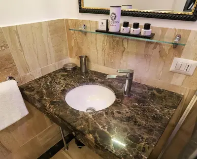 a bathroom sink with a marble counter top at Minerva Relais in Rome