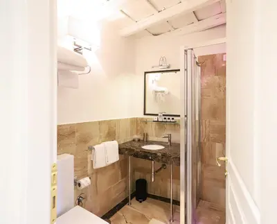 a bathroom with a sink and a mirror at Minerva Relais in Rome