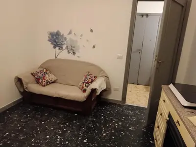 a living room with a couch and a mirror at Romamor 2 in Rome