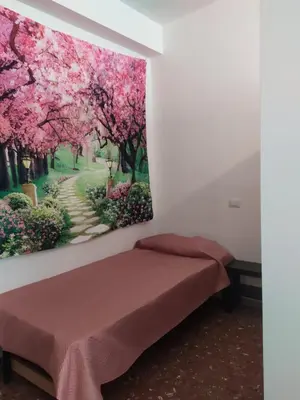 a bedroom with a painting on the wall at Romamor 2 in Rome