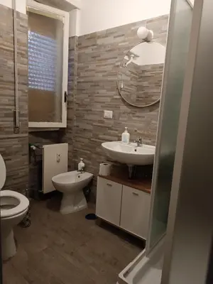 a bathroom with a sink and a toilet and a mirror at Romamor 2 in Rome
