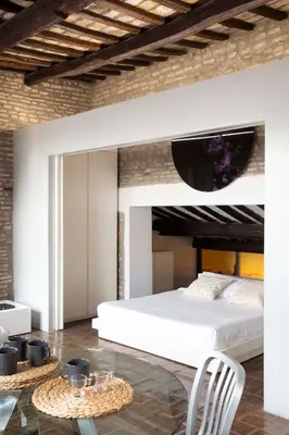 a bedroom with a white bed and a table at Monti apartment BDB in Rome