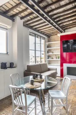 a living room with a glass table and chairs at Monti apartment BDB in Rome
