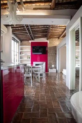 a dining room with a table and a red wall at Monti apartment BDB in Rome