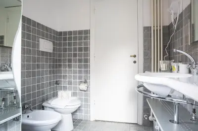 a bathroom with a toilet and a sink at Collection Spanish Steps Apartments in Rome