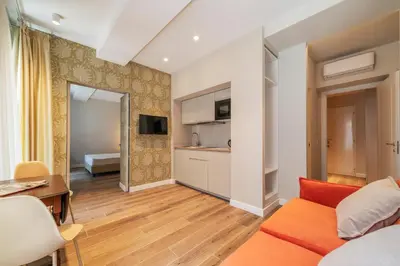 a living room with a couch and a table at Luxury Corso Suite - DesignD Stays in Rome