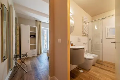 a bathroom with a toilet and a sink and a shower at Luxury Corso Suite - DesignD Stays in Rome