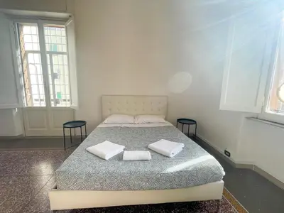 a bedroom with a bed with two towels on it at Angelico Boutique Apartment in Rome