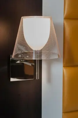 a light on a wall with a mirror at DVE Suite Rome in Rome