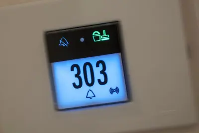 an electronic clock on a white wall at DVE Suite Rome in Rome